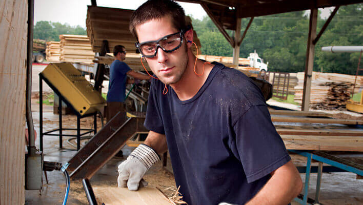 Worker wearing foam-padded safety goggles