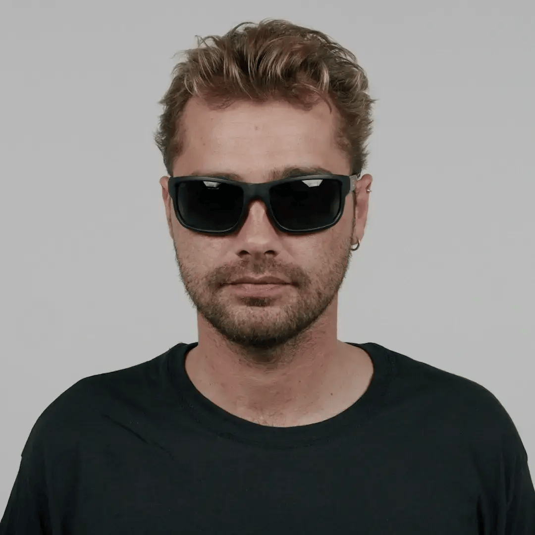 CO Eyewear Magneto Z87+ Safety Glasses with matte black frame and dark lenses on a man.