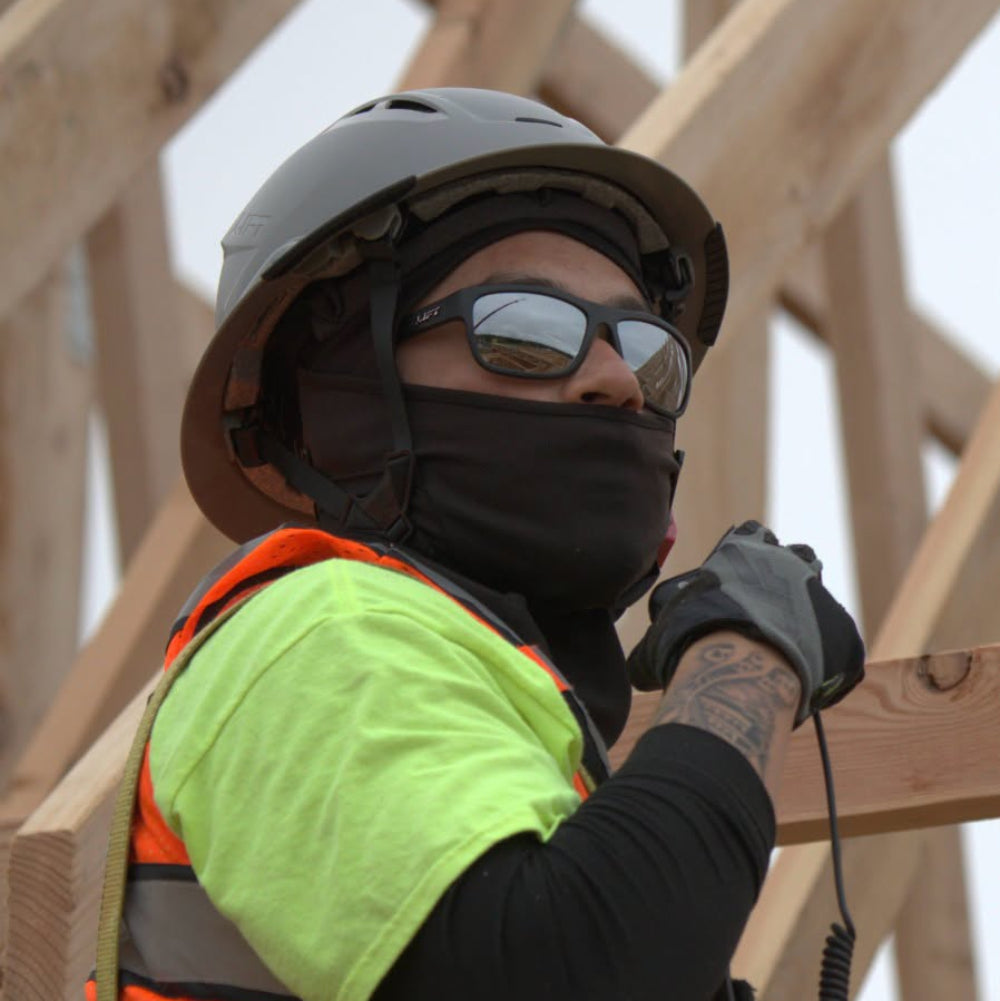 Construction worker wearing Lift Safety Banshee Safety Glasses and Lift Safety Full-Brim Hard Hat.