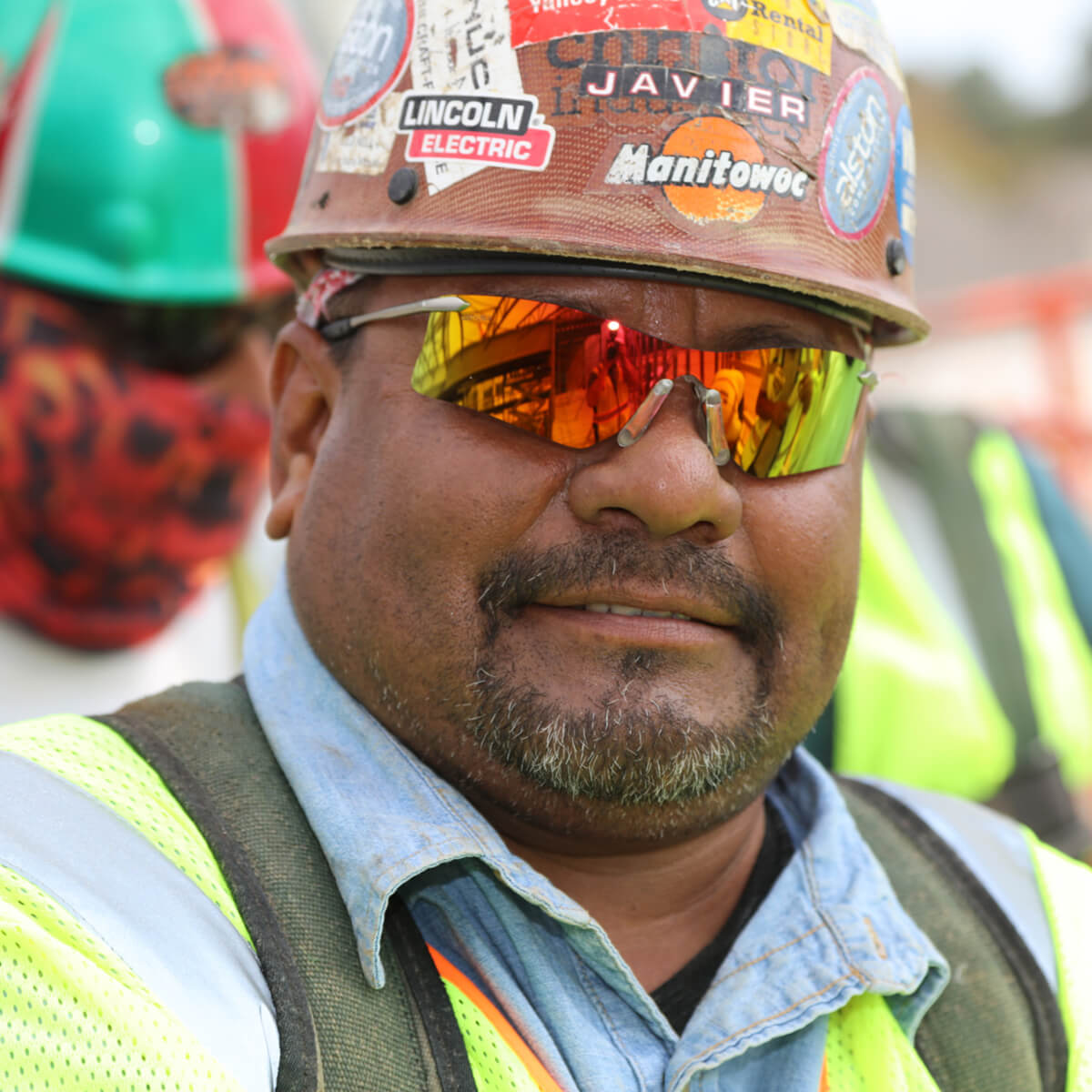 MCR Safety T411R Rubicon T4 Safety Glasses with Fire Mirror Lens worn by construction worker